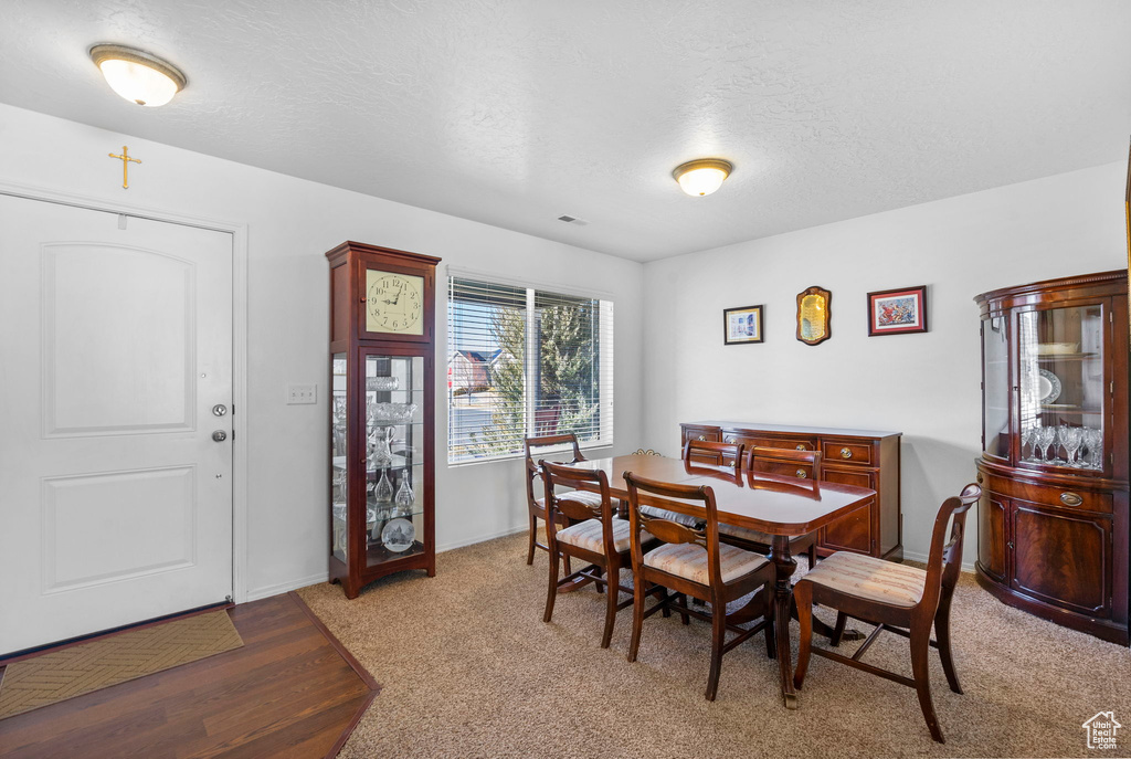 Dining space with a textured ceiling and baseboards