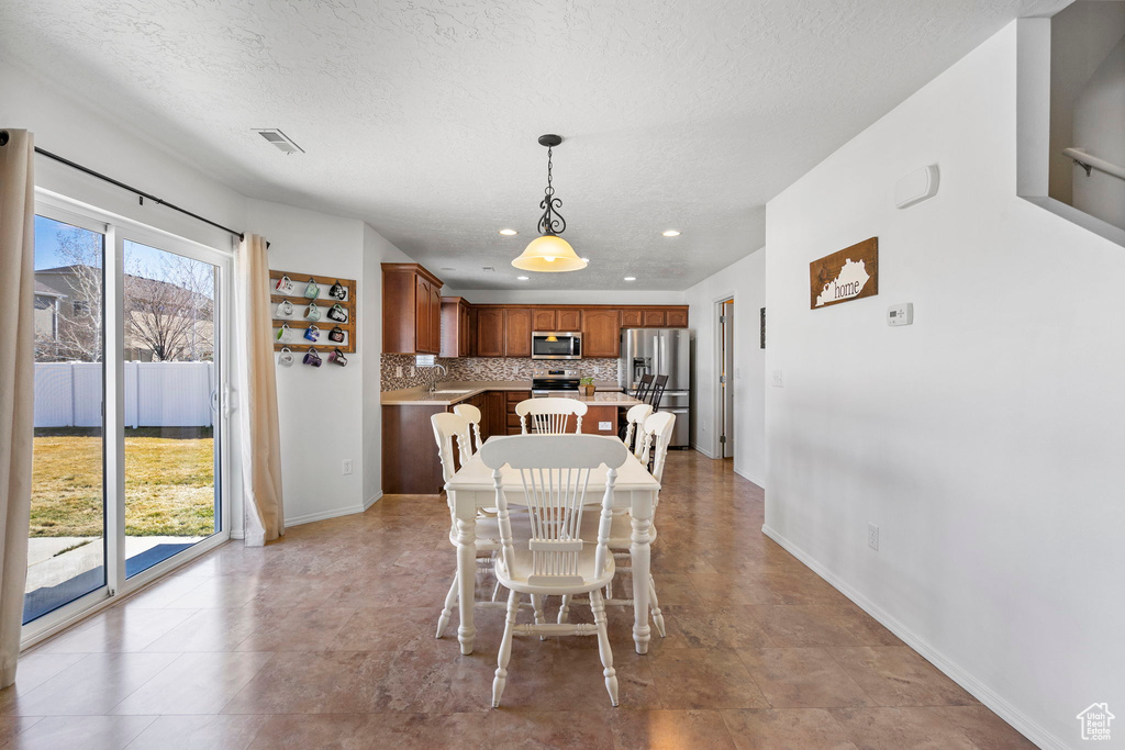 Dining space featuring visible vents, plenty of natural light, and baseboards