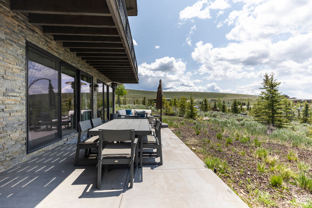 View of patio featuring outdoor dining area and a view of countryside