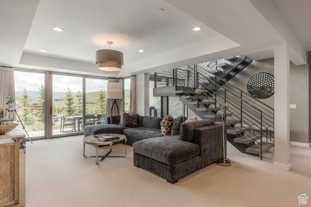 Living room with carpet, stairway, and recessed lighting