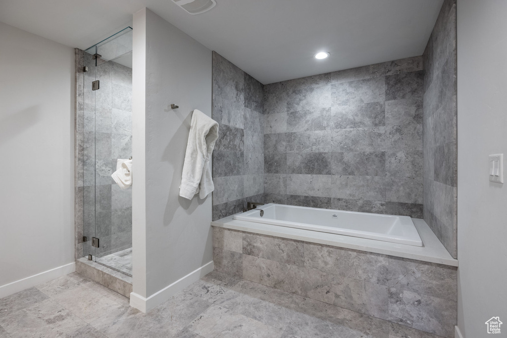 Full bathroom with a bath and a shower stall
