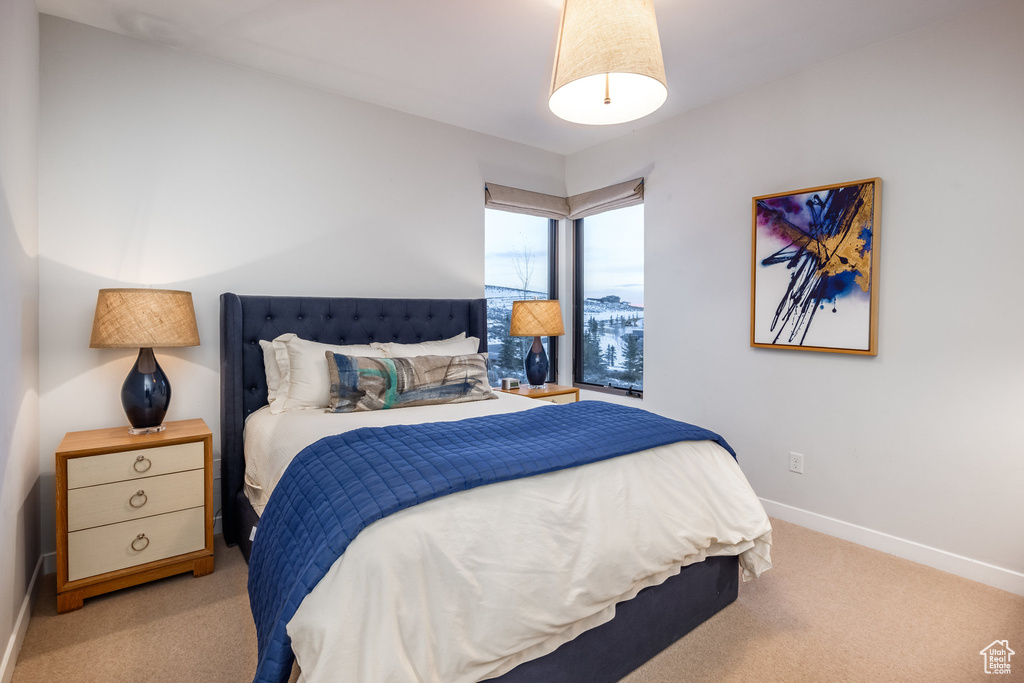 Carpeted bedroom featuring baseboards