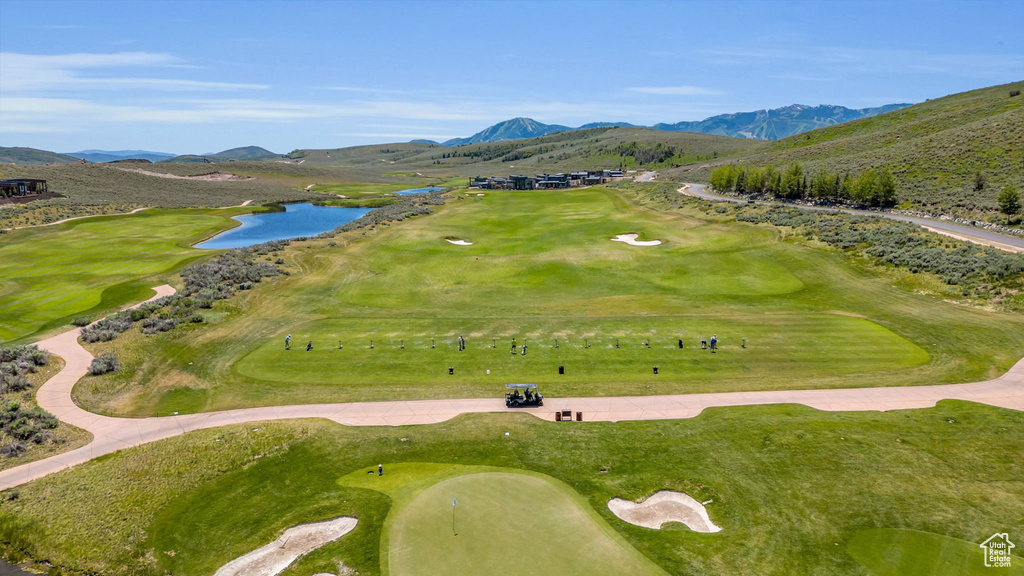 View of community with a water and mountain view and golf course view