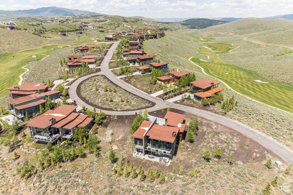 Aerial overview of property's location featuring mountains and a golf course
