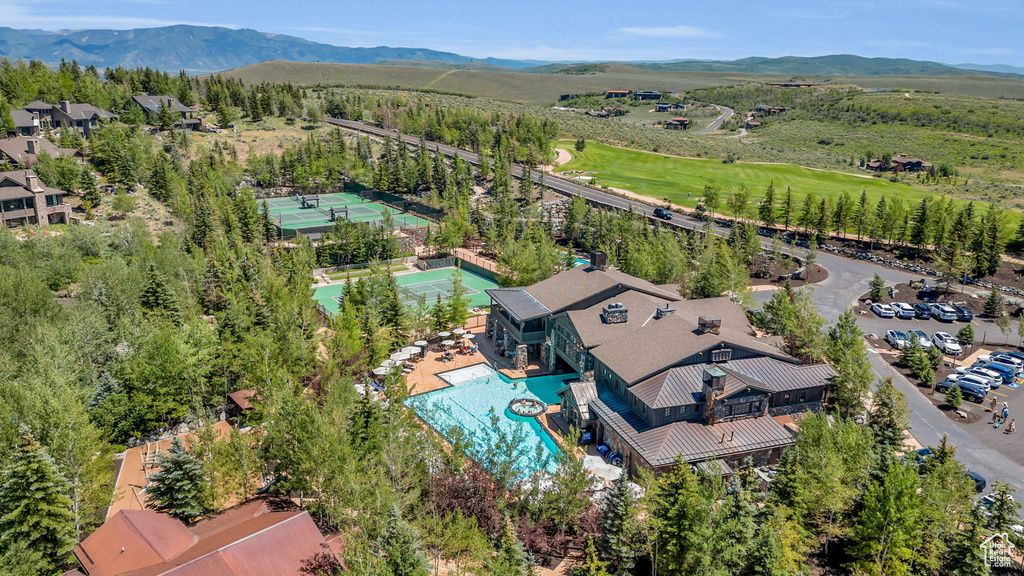 Aerial view of a pool area and a mountainous background