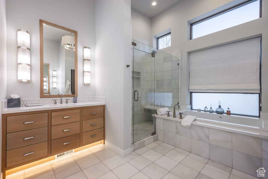 Bathroom with vanity, tile patterned floors, a stall shower, and a bath