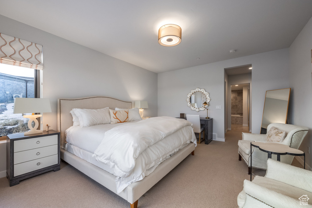 Bedroom featuring light colored carpet and baseboards