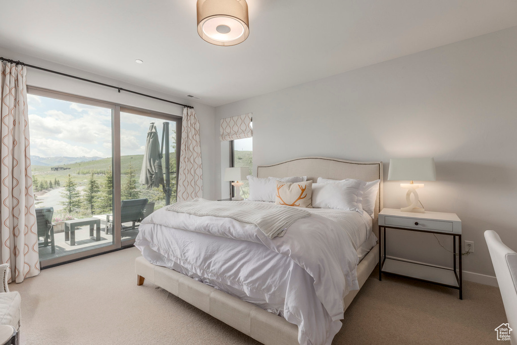 Bedroom featuring access to outside and carpet flooring