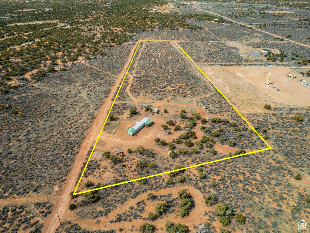 Birds eye view of property featuring a desert view and a rural view