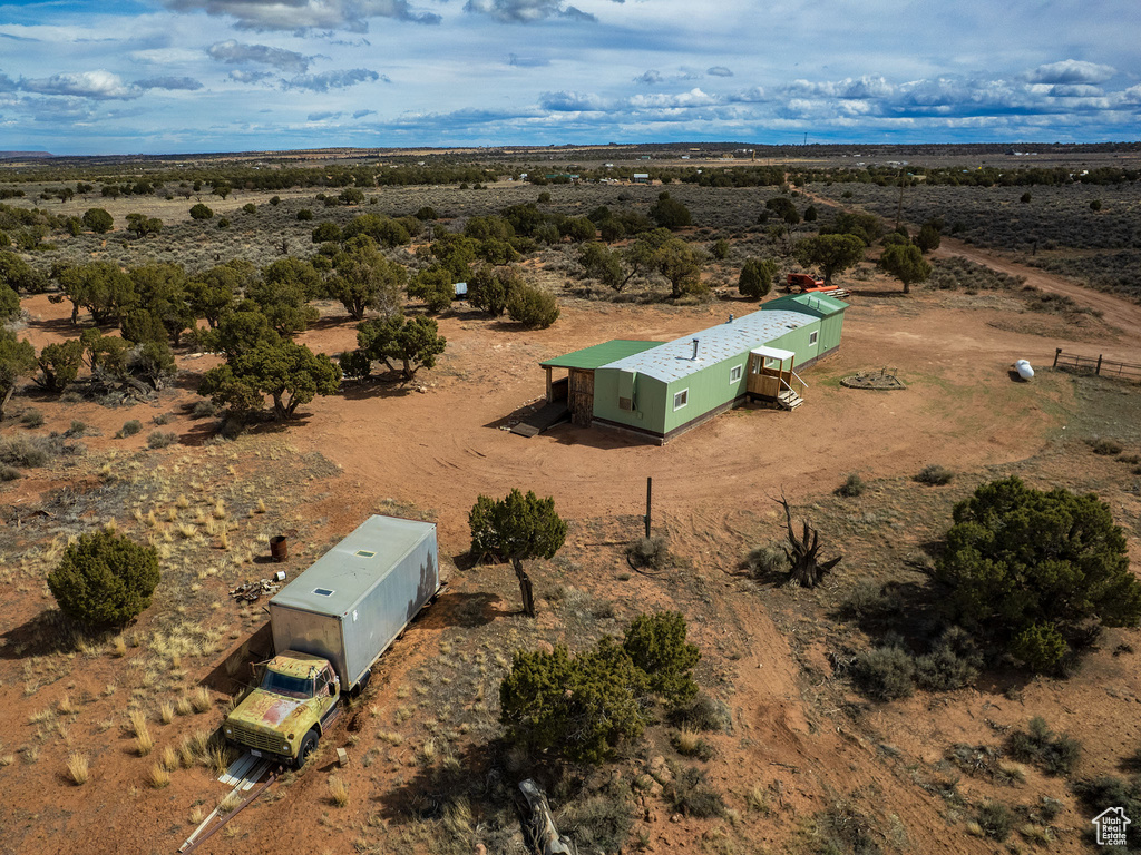 Birds eye view of property with a desert view and a rural view