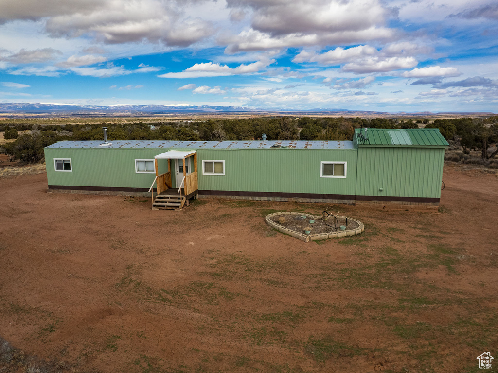 Exterior space with a mountain view and metal roof