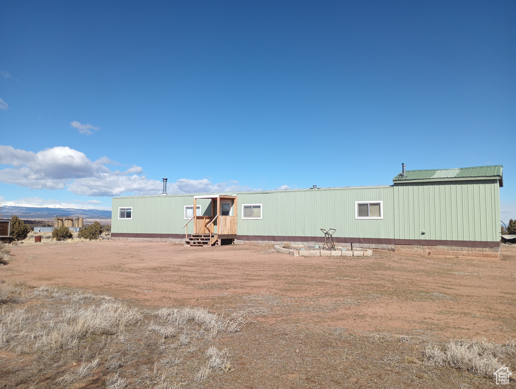 Rear view of property with metal roof