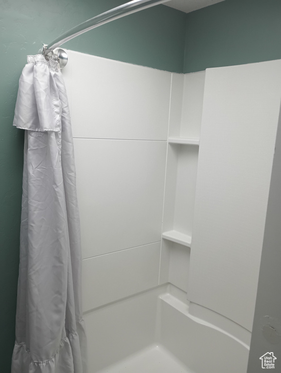 Full bath featuring a shower with curtain