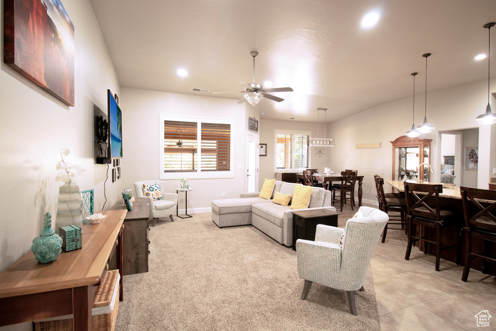Living room featuring a ceiling fan and recessed lighting