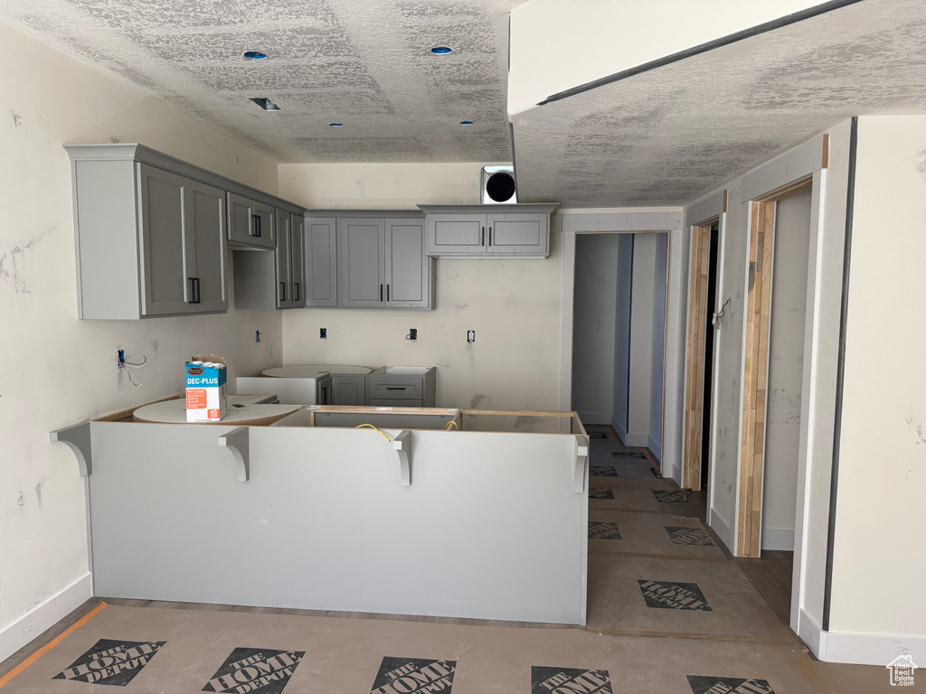 Kitchen with baseboards and gray cabinets