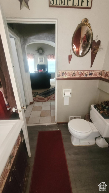Half bathroom featuring toilet and tile patterned floors