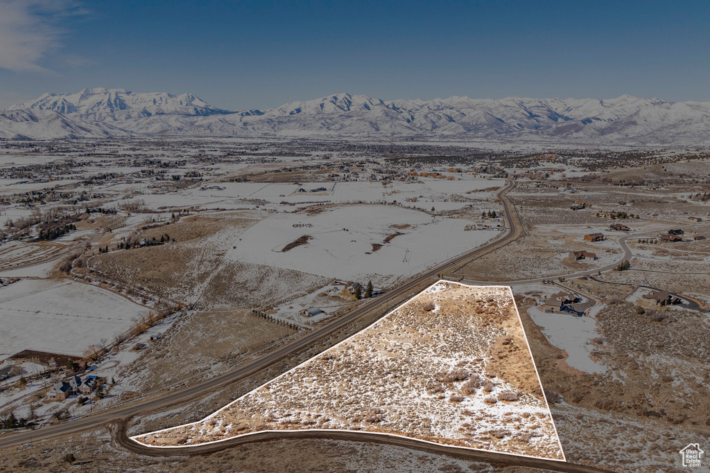 Aerial view of property and surrounding area with mountains