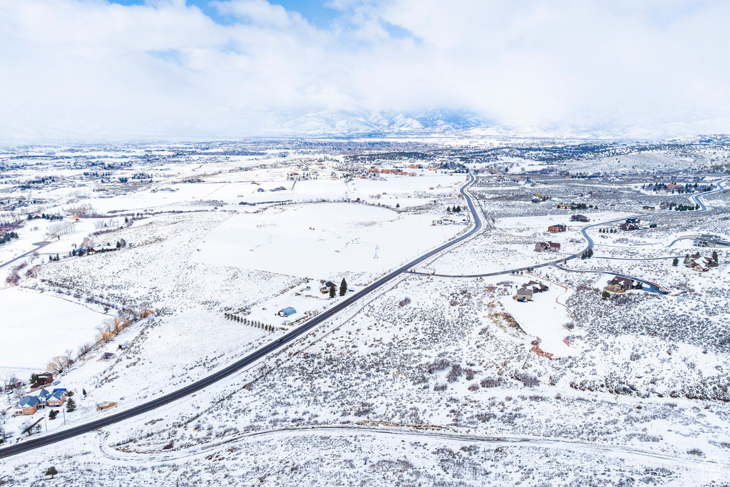 Snowy aerial view featuring a mountain view