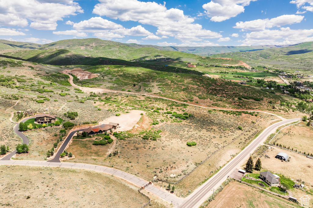 Aerial view of property's location with a mountain backdrop and rural landscape