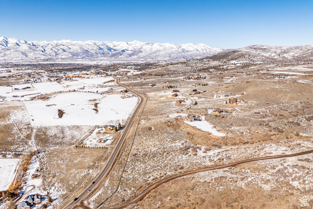 Aerial overview of property's location featuring a mountainous background