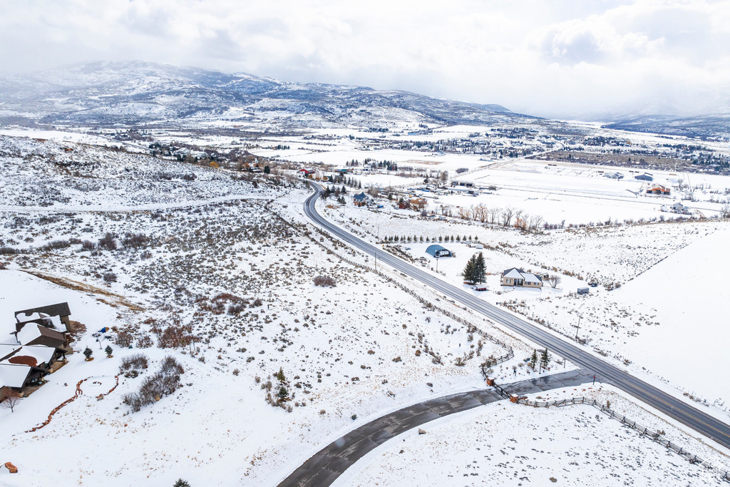 Snowy aerial view featuring a mountain view