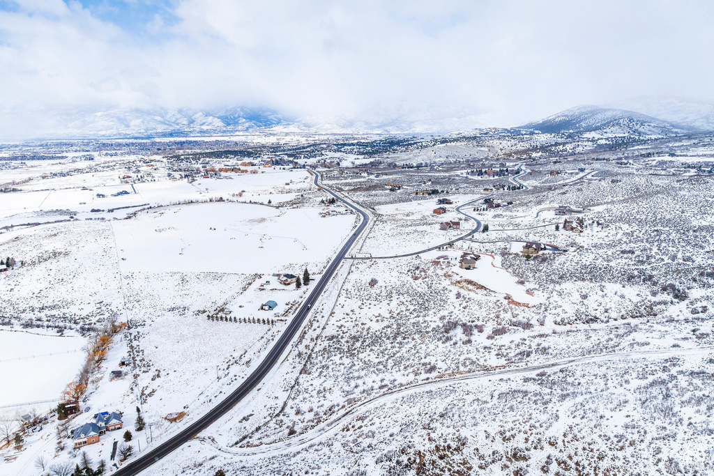 Snowy aerial view featuring a mountain view