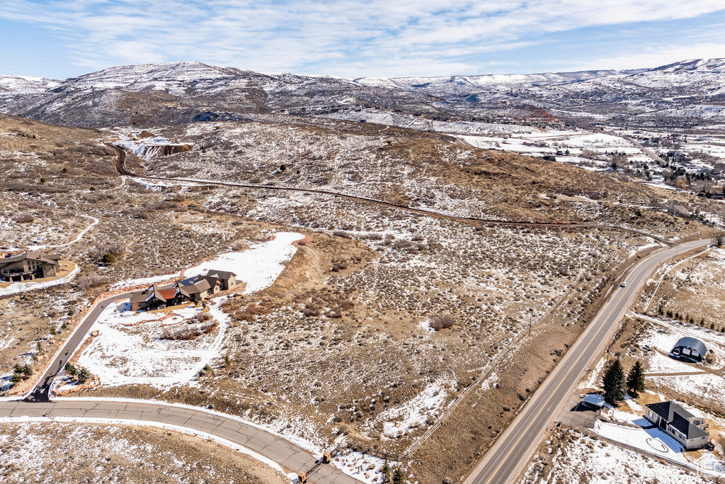 Snowy aerial view featuring a mountain view