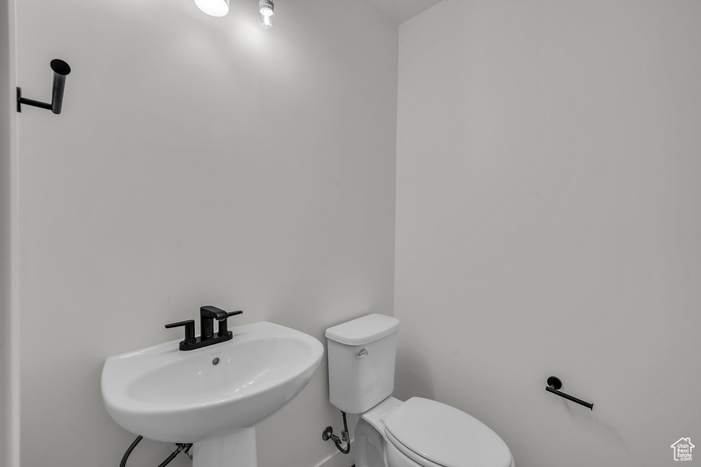 Half bathroom featuring a sink and toilet