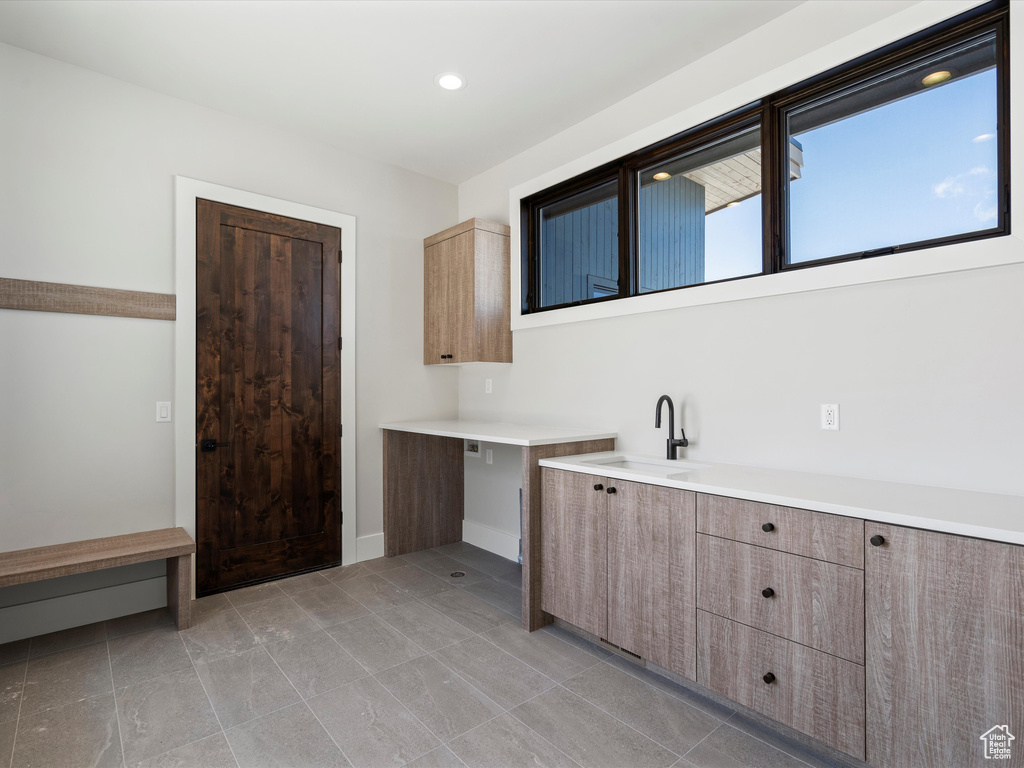 Laundry area with recessed lighting and a sink