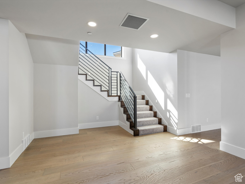 Interior space with recessed lighting, visible vents, baseboards, and wood finished floors