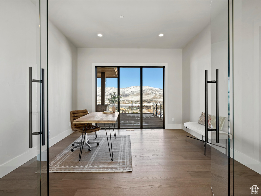 Office with recessed lighting, wood finished floors, a mountain view, and baseboards