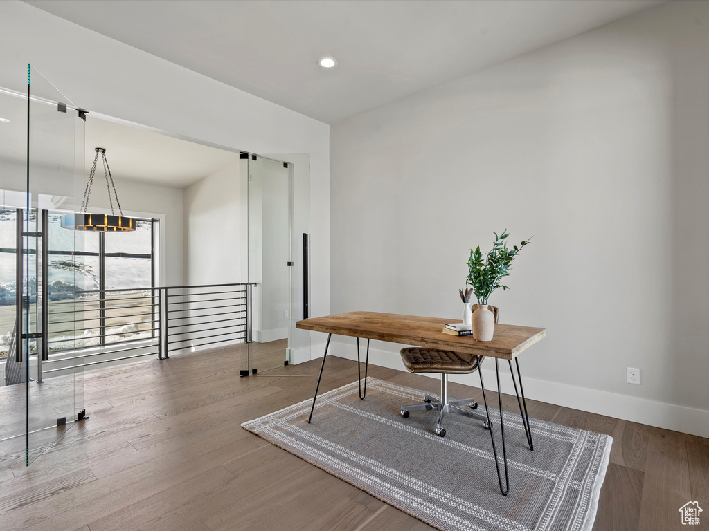 Home office featuring recessed lighting, baseboards, and wood finished floors