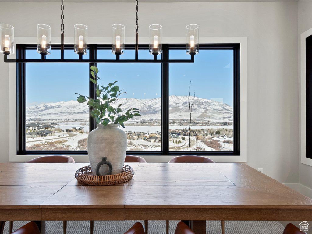 Unfurnished dining area with a mountain view and a chandelier