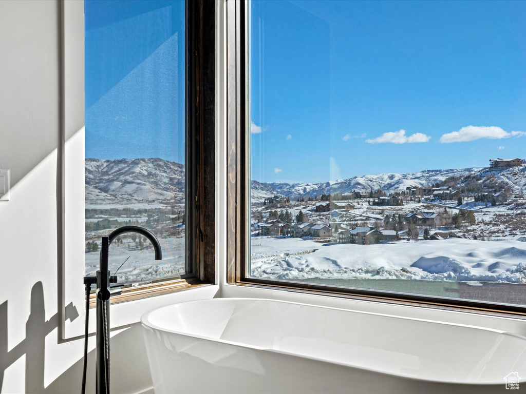 Full bathroom featuring a freestanding tub and a mountain view