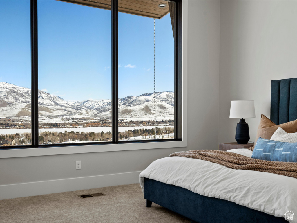 Bedroom with carpet, visible vents, a mountain view, and baseboards