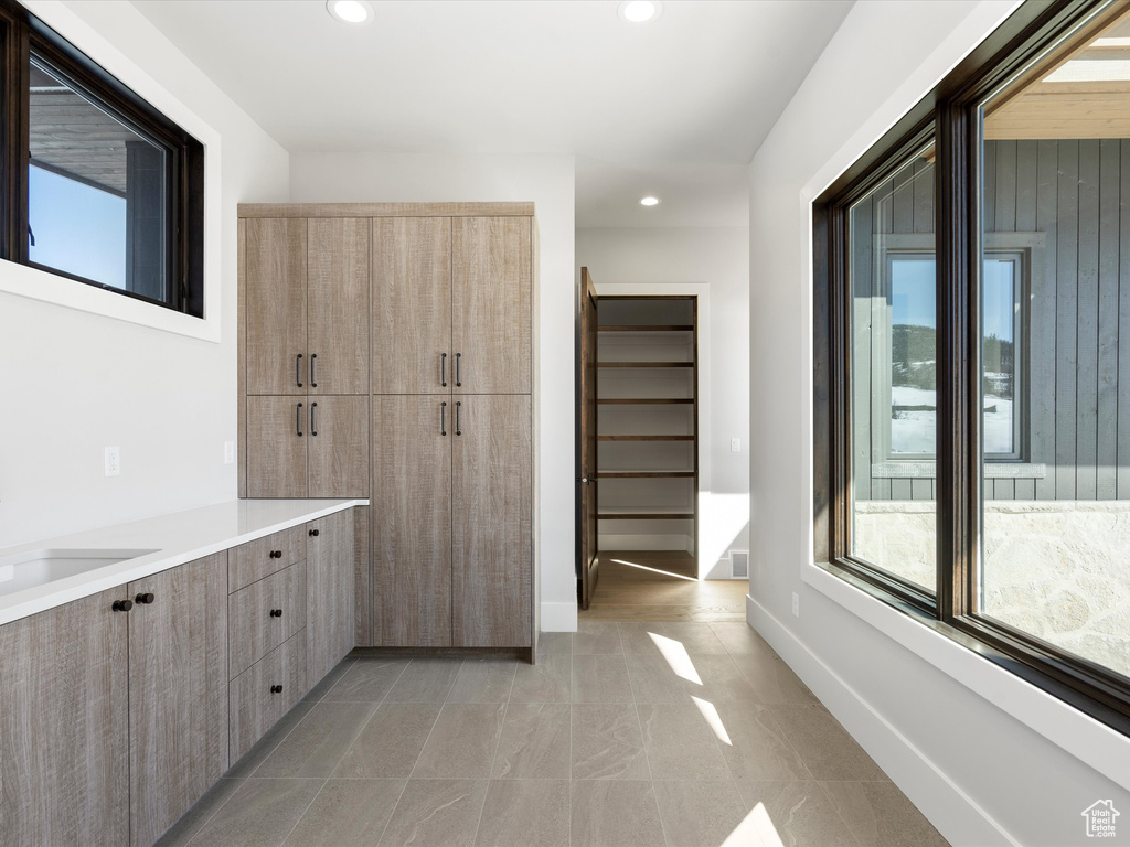 Bathroom featuring recessed lighting, a healthy amount of sunlight, and baseboards