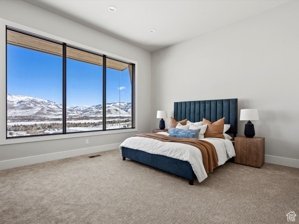 Carpeted bedroom featuring visible vents, baseboards, a mountain view, and recessed lighting