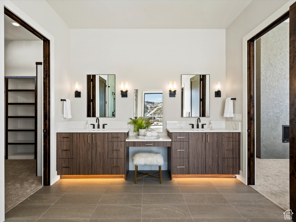 Full bathroom with tile patterned flooring, two vanities, and a sink