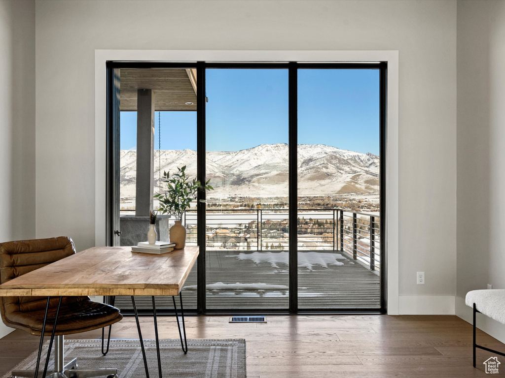 Doorway featuring visible vents, a mountain view, baseboards, and wood finished floors