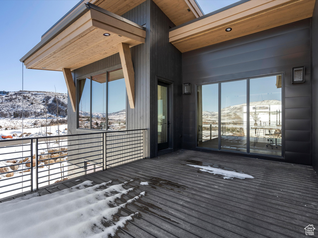 Snow covered deck with a mountain view