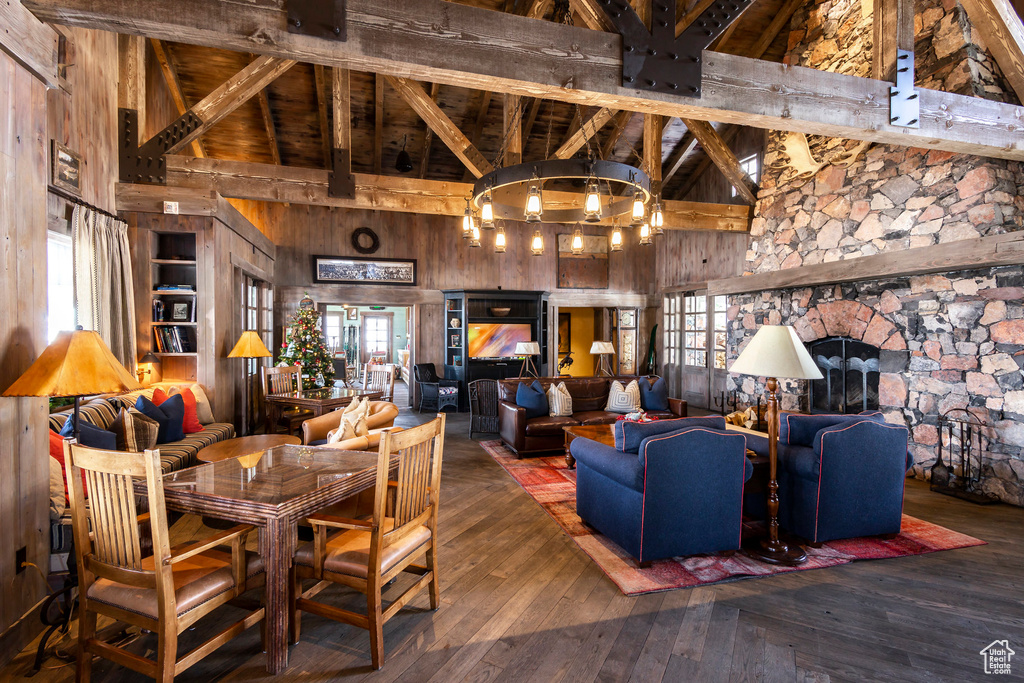Lobby with high vaulted ceiling, beam ceiling, wood walls, and wood ceiling