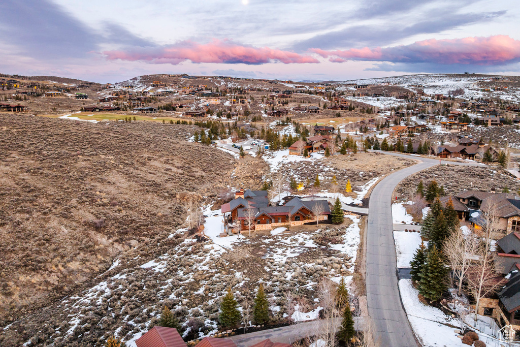 Snowy aerial view featuring a residential view and a mountain view