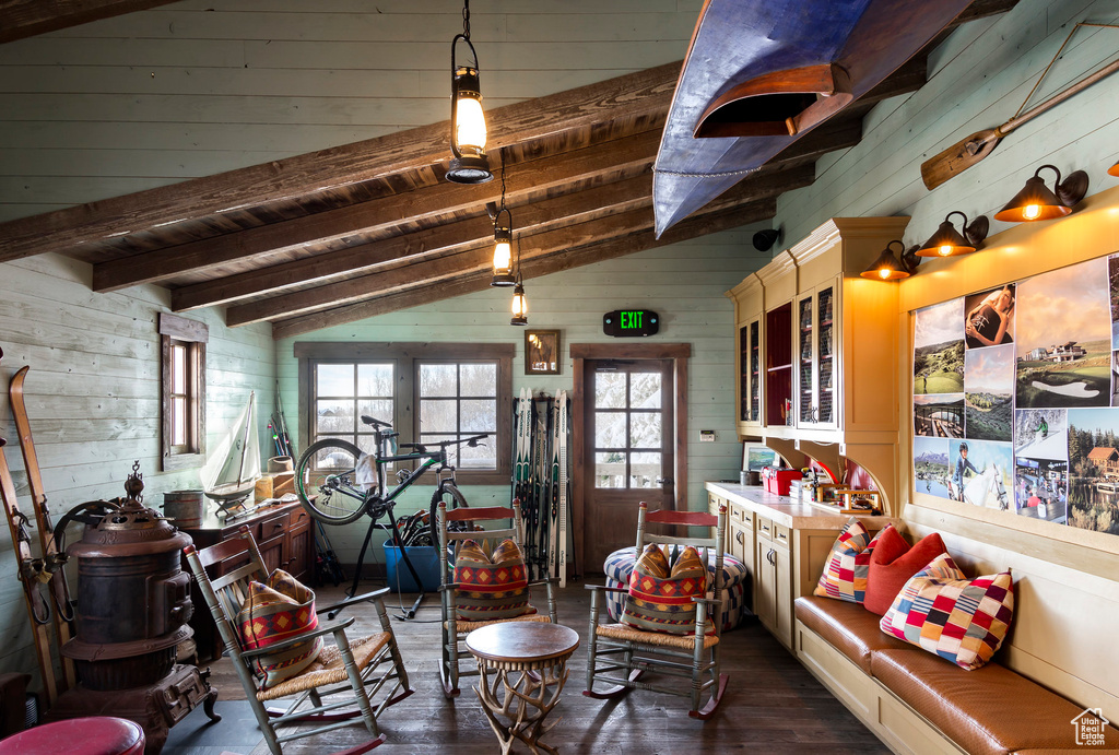 Living room featuring wood walls, dark wood-type flooring, and wooden ceiling