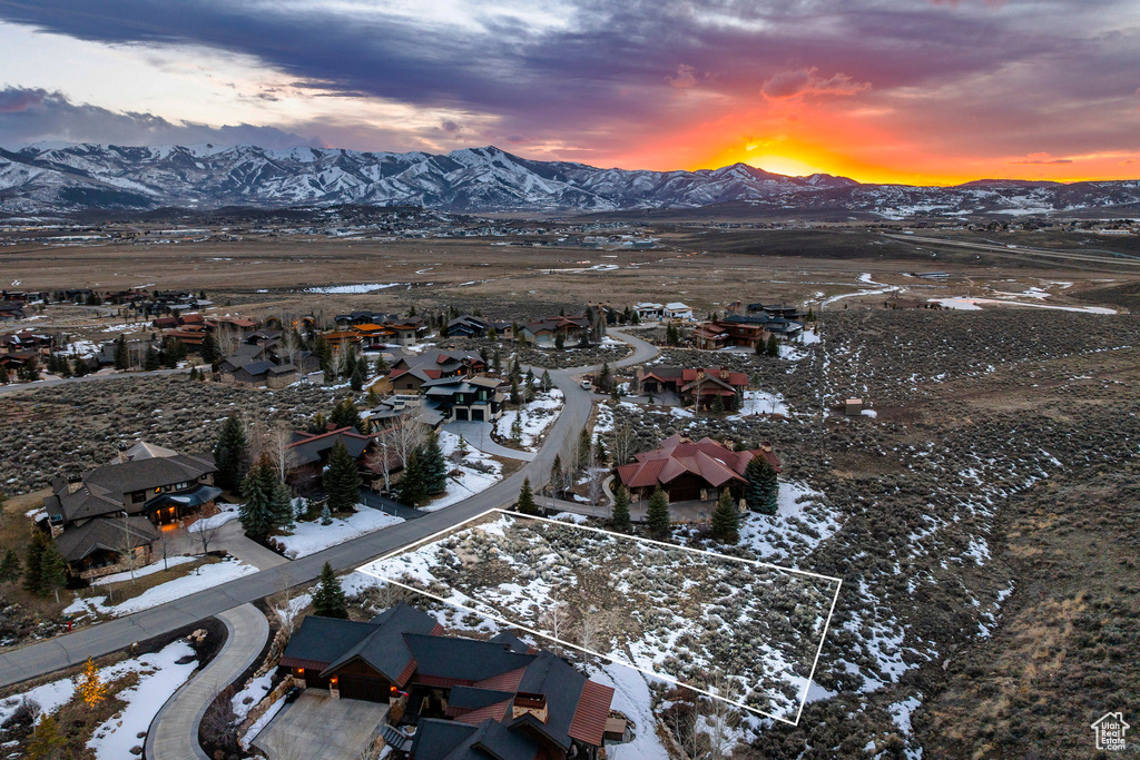 Snowy aerial view with a mountain view and a residential view