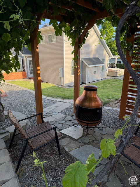 View of patio featuring an outdoor fire pit