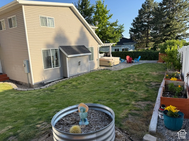 Rear view of house with a garden and a patio area