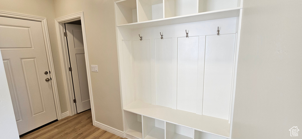 Mudroom with baseboards and wood finished floors
