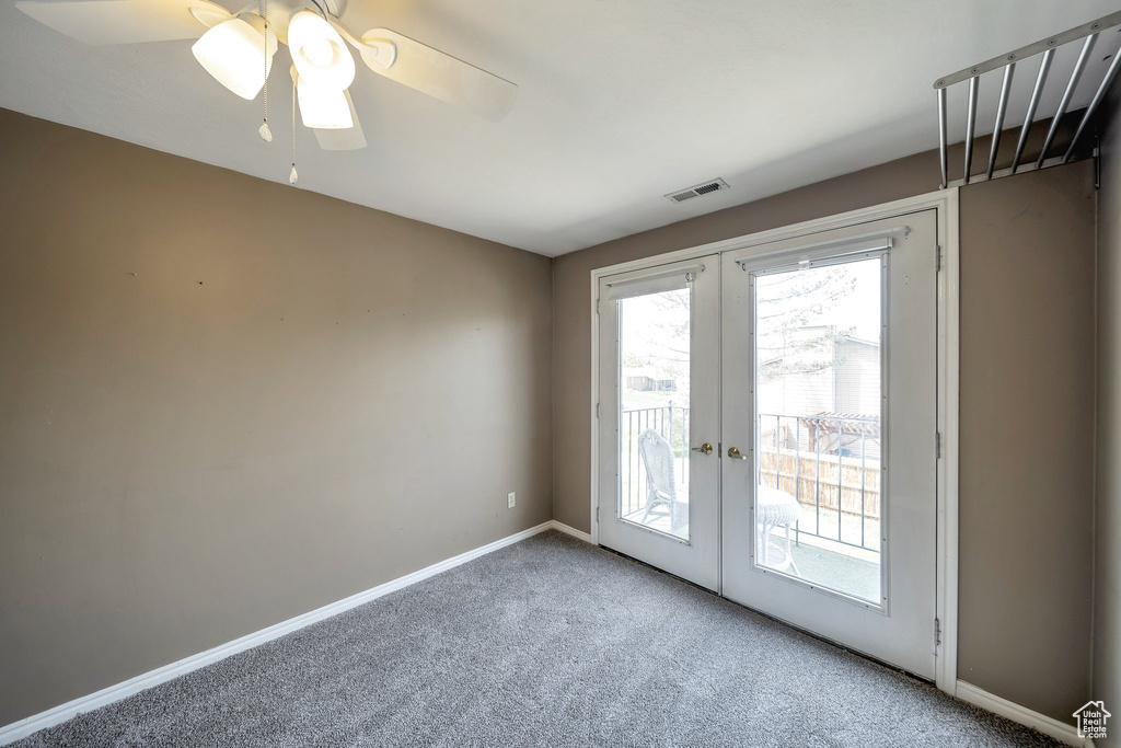 Doorway to outside featuring carpet, visible vents, french doors, and plenty of natural light