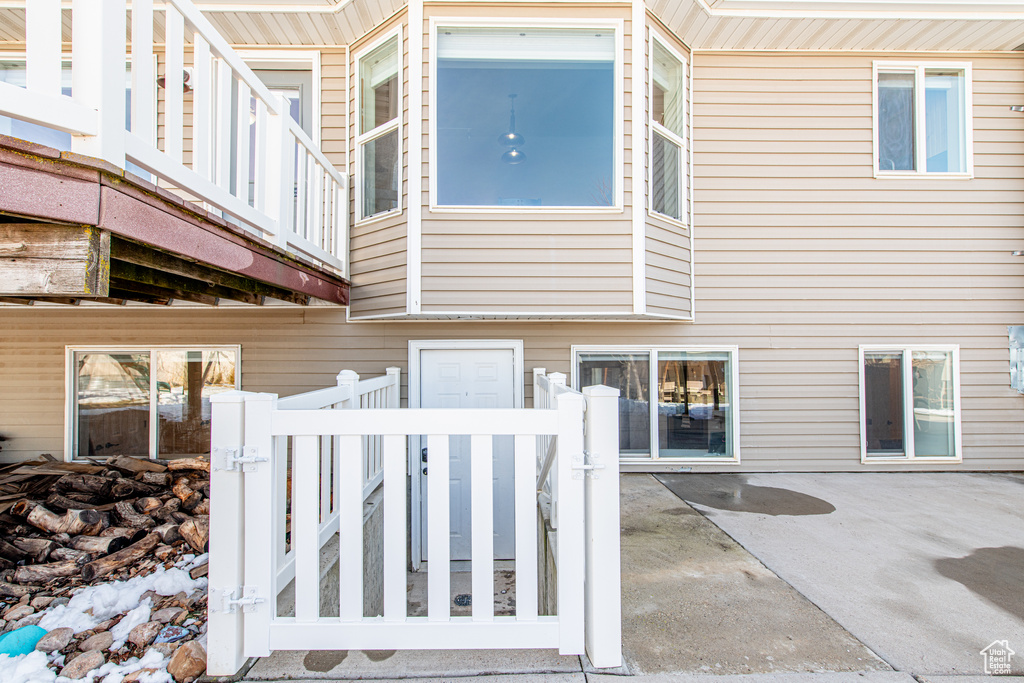 Back of property featuring a fenced front yard and a patio