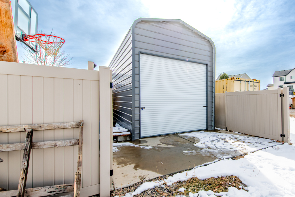 Garage with a storage unit and fence